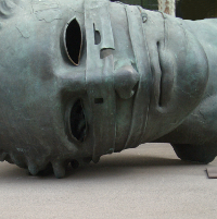 Image of a bandaged statue lying on its side